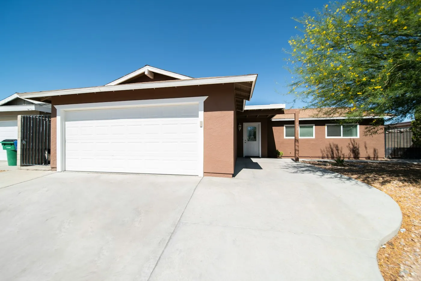New concrete driveway in front of a single-story home