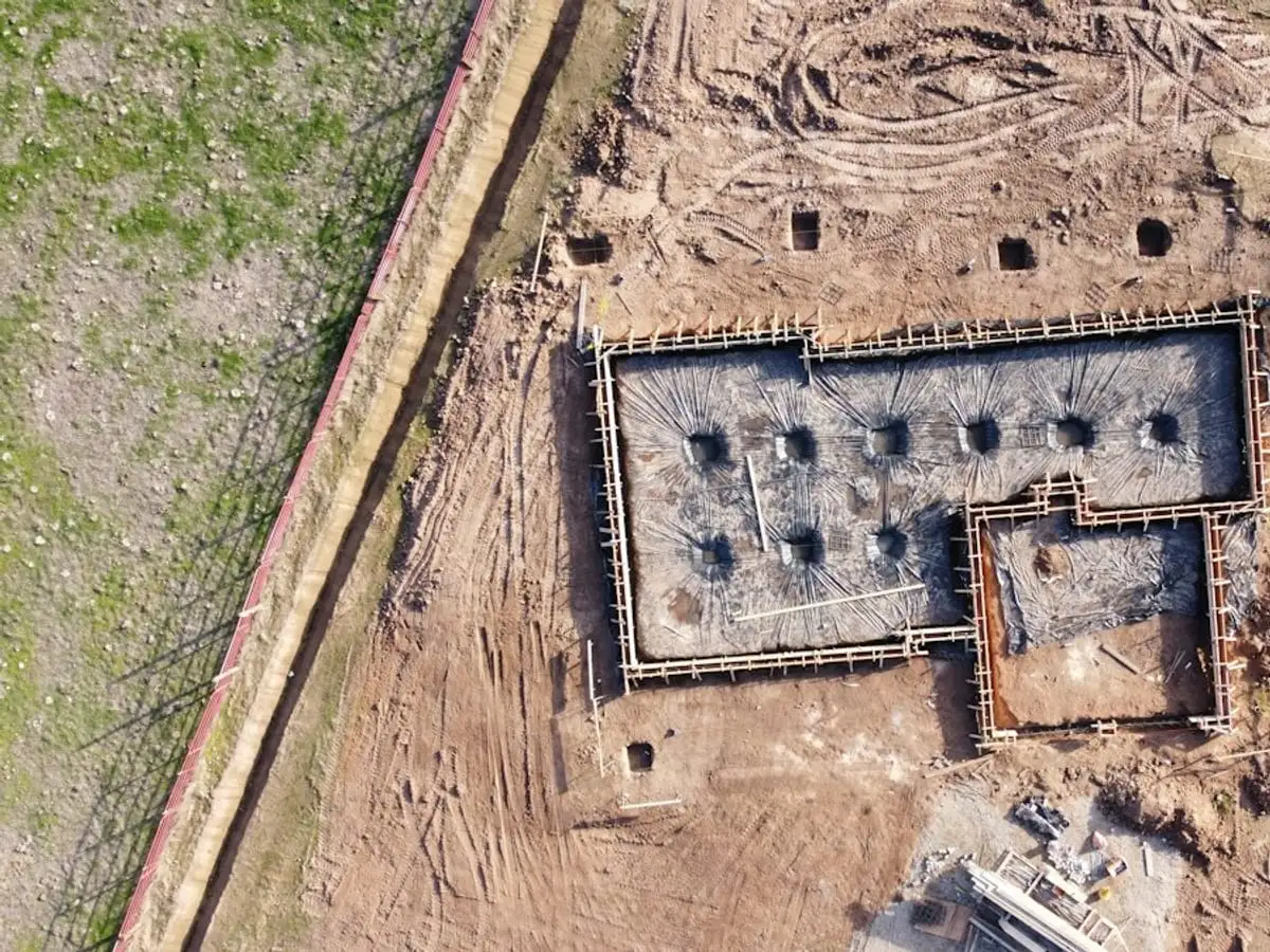 Aerial view of a new house foundation on a cleared lot