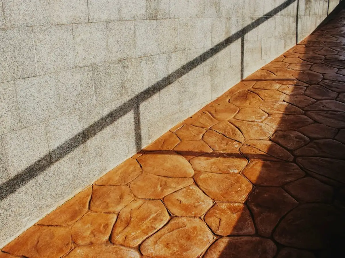 Stamped concrete walkway with a stone pattern in warm tones
